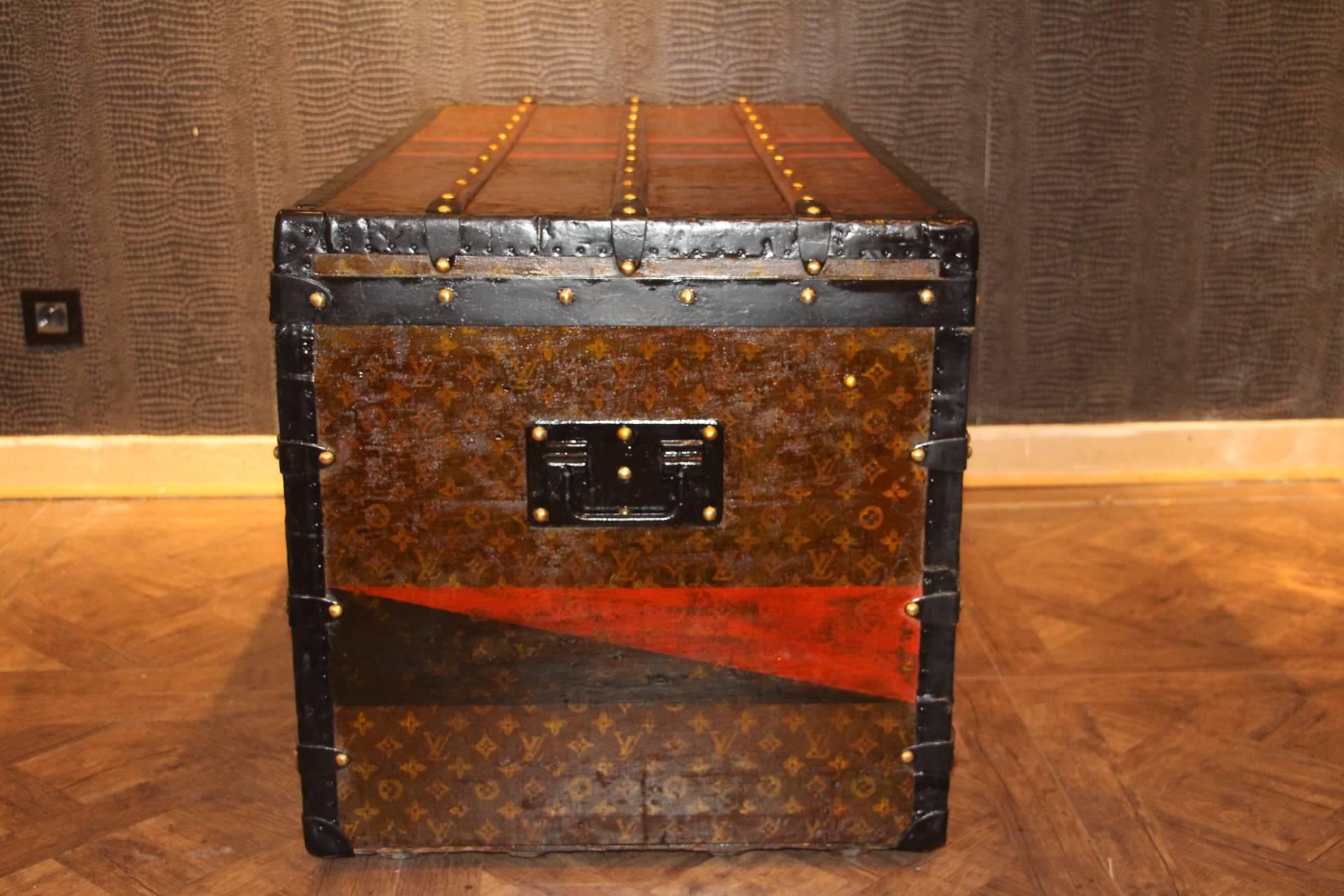 This beautiful Louis Vuitton trunk is all stenciled LV monogram canvas, with steel and brass locks and steel trim. It has got a remarkable patina. Red and black identity stripes.
Its interior has been relined few years ago.Removable tray.
Its