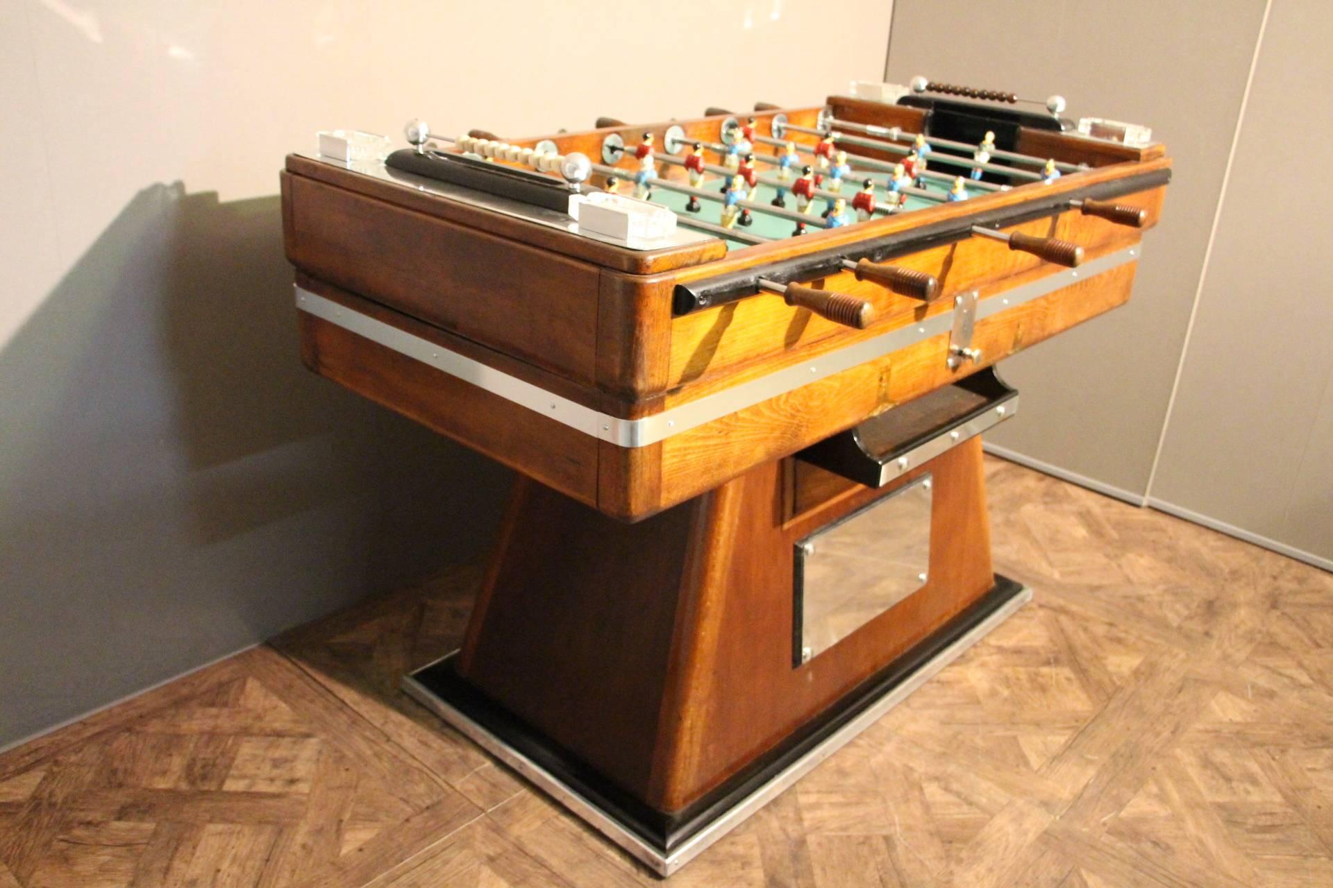 This French beechwood and ebonized table on shaped supports has got painted steel blue and red players and polished aluminum fittings. It is a beautiful decorative piece as well as a fabulous game table in working order.