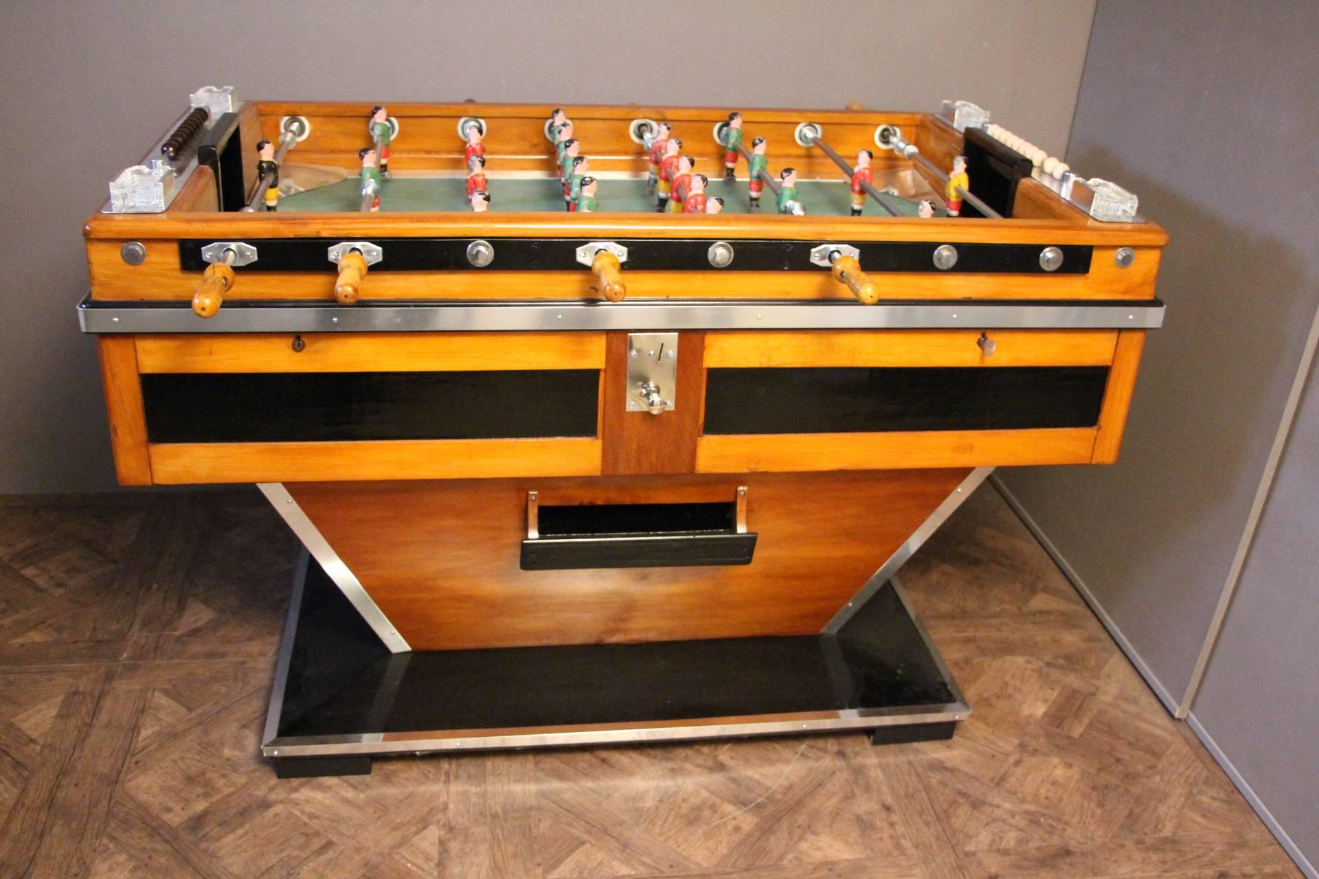 This magnificent French beechwood and ebonized table on shaped supports has got painted steel players, four crystal ashtrays by Lalique and polished aluminum fittings. It is a beautiful decorative piece as well as a fabulous game table in working