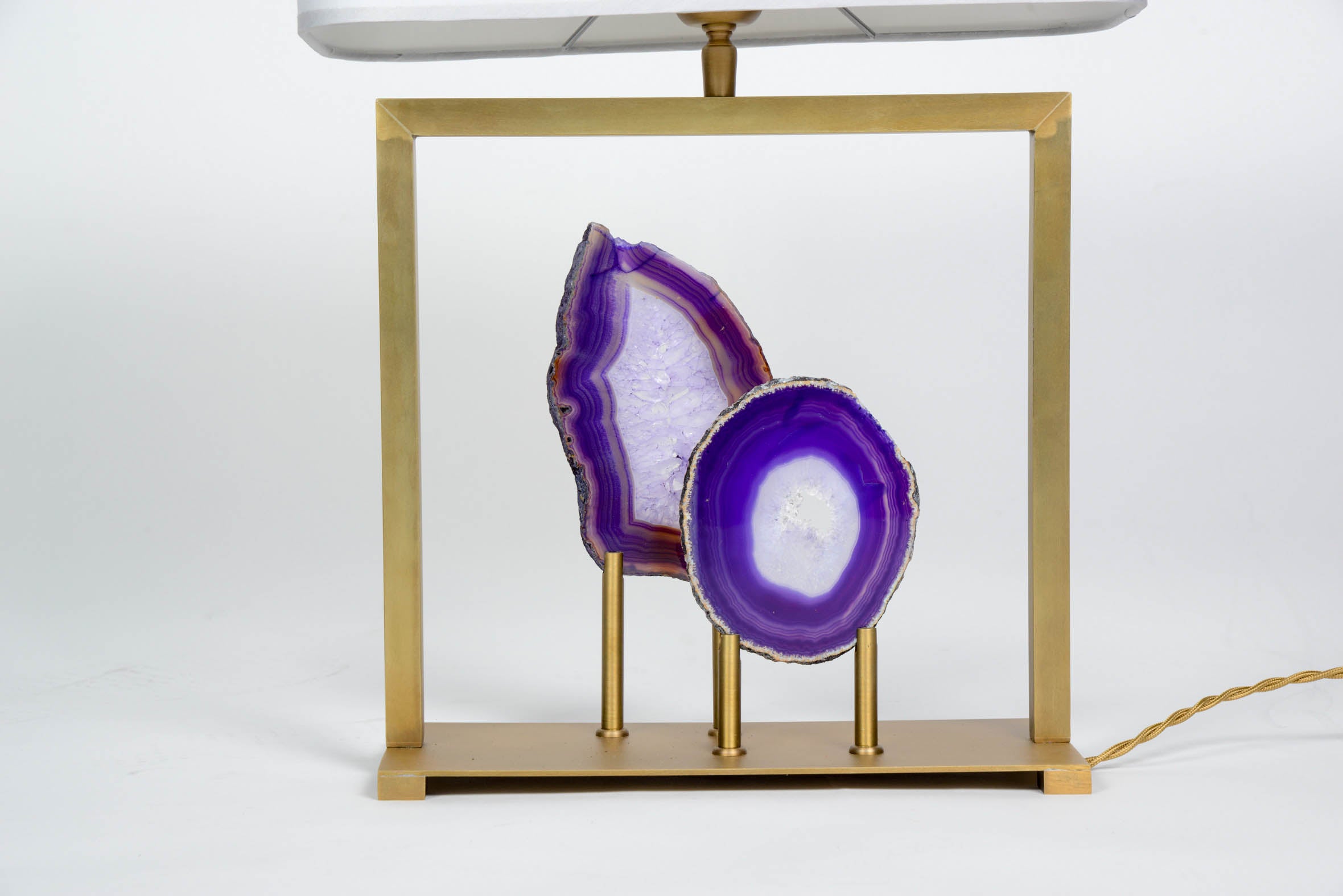 Charming small lamp made of a polished brass frame setting two slices of purple agates.

Glustin Luminaires creation.

New electrification, can be rewired for american standards.