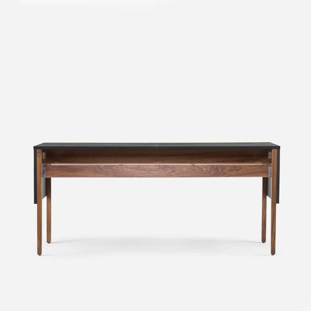 Drape desk provides visual expression through thoughtful design: The tabletop is articulated as a “drape” that falls over the table legs, lending a sense of continuity to the silhouette. Two drawers tucked underneath run the length of the table. On