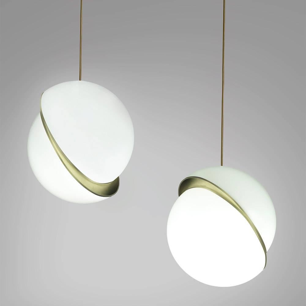 An illuminated sphere sliced in half to reveal a crescent-shaped brushed brass fascia, Crescent Light seamlessly combines the solid and the opaque. Also available as a table light.

Opaque acrylic and brushed brass.

15 3/4" D x 17
