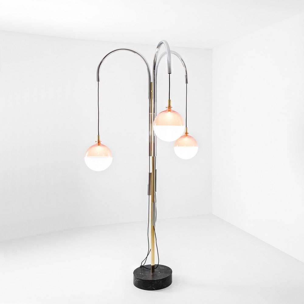 Designed in 2016, this floor lamp is composed of polished brass and curved chrome tubes. It features an adjustable spherical lampshade in glass; one half colored and one sandblasted.

DIMORESTUDIO’s Progetto Non Finito collection (unfinished in