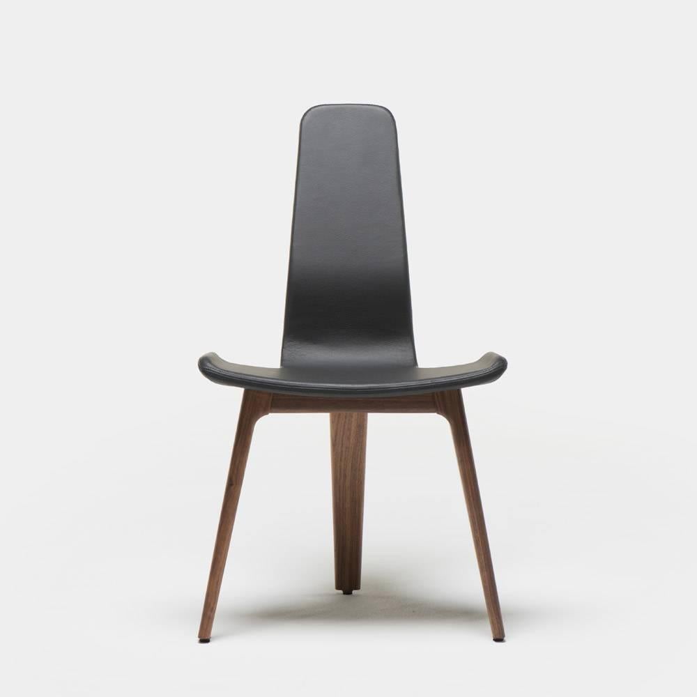 Matthew Hilton's Tapas chair is a light and comfortable high back dining chair of singular nature with a nod towards the strong forms of Spain's characteristic objects. The unique shape of the seat shell set upon three legs, makes a compact piece of