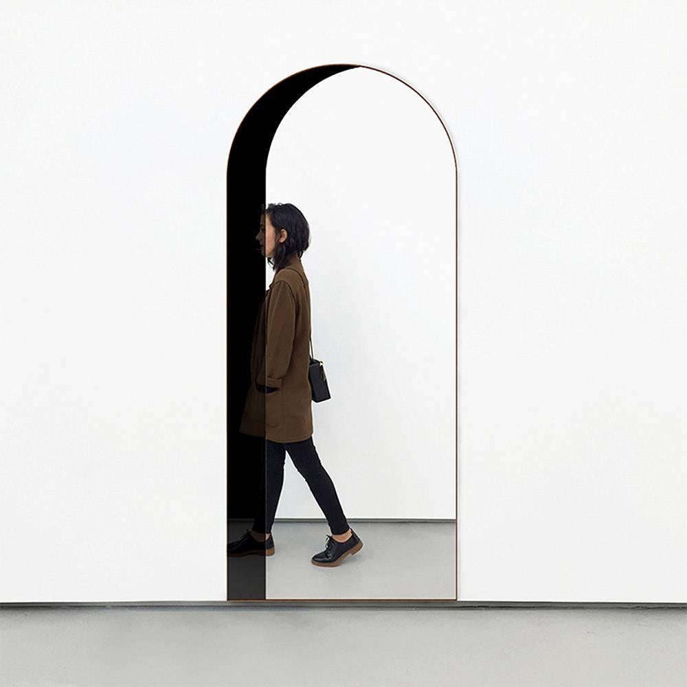 Arch mirrors are composed of pieces of glass mirror of varying tints that together create an elegant optical illusion of three dimensional windows and doorways. The tints are arranged by tone to enhance the shaded effect on the different planes of