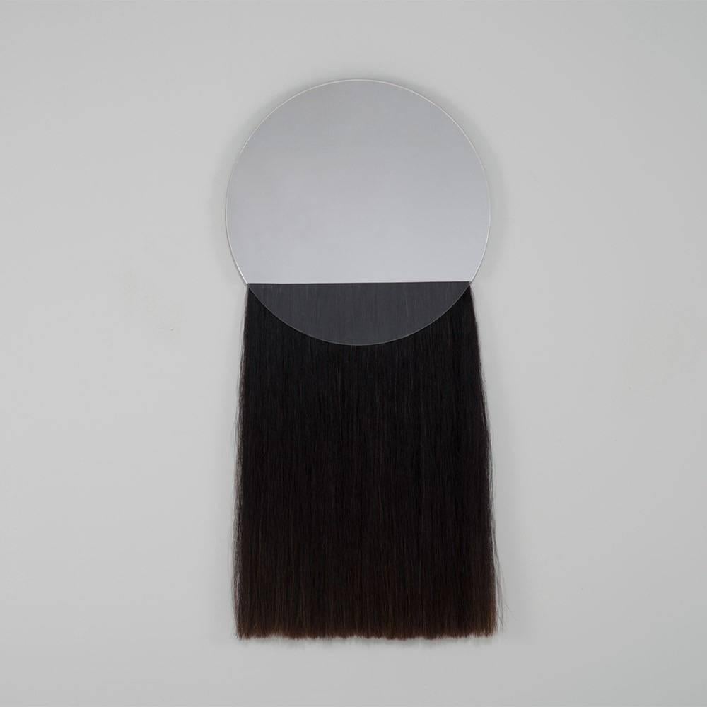 Natural Mongolian horsehair is layered with mirrored and translucent glass, creating an unfamiliar, Minimalist union of materials. Available with clear, grey, bronze or peach glass mirror and blonde or black horsehair. Limited edition of 25 and