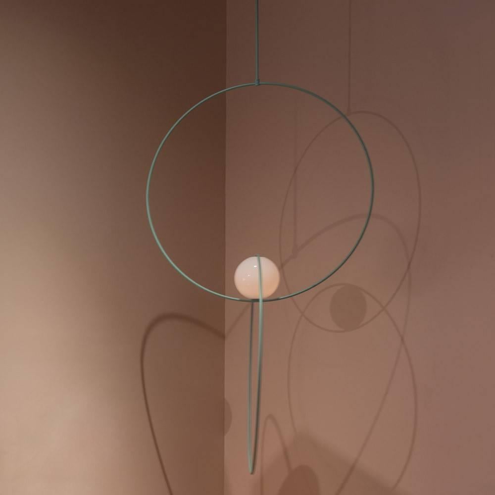 Michael Anastassiades’ Loop Collection, created exclusively for The Future Perfect. explores balance, color and minimal shapes. Thin green rings hold three orbital lights in the standout Triple Loop Suspension. Working with the color and motif, the