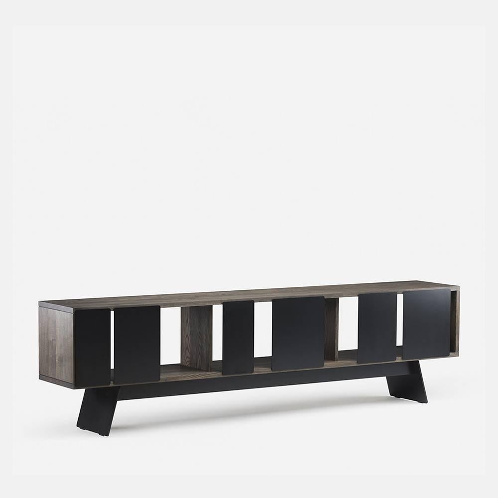 Long planks of solid hardwood create a cabinet with an open form, while the sliding doors articulating the facade partially conceal the cabinet contents, engaging play between positive and negative space. Available in two widths and one, two or