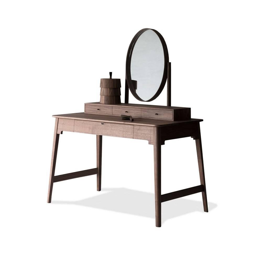 The Lana dressing table's lower lockable drawer houses a removable leather lined jewelry tray, and a drawer divider. The surface box consists of three smaller drawer sections and the dressing table comes with a stack of three round solid walnut