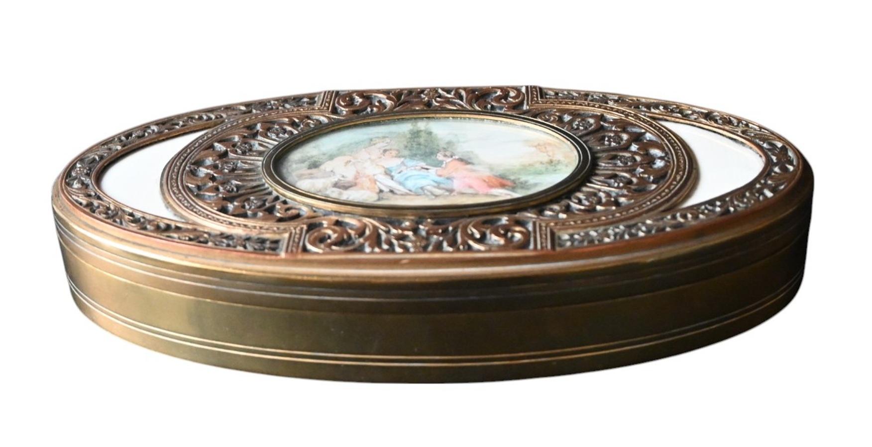 Offered for sale is an exquisite antique French bronze jewelry or trinket box, featuring an elaborate pierced Rococo-style design and a finely hand-painted miniature pastoral scene, signed P. Brin.

The lid is adorned with intricate floral and
