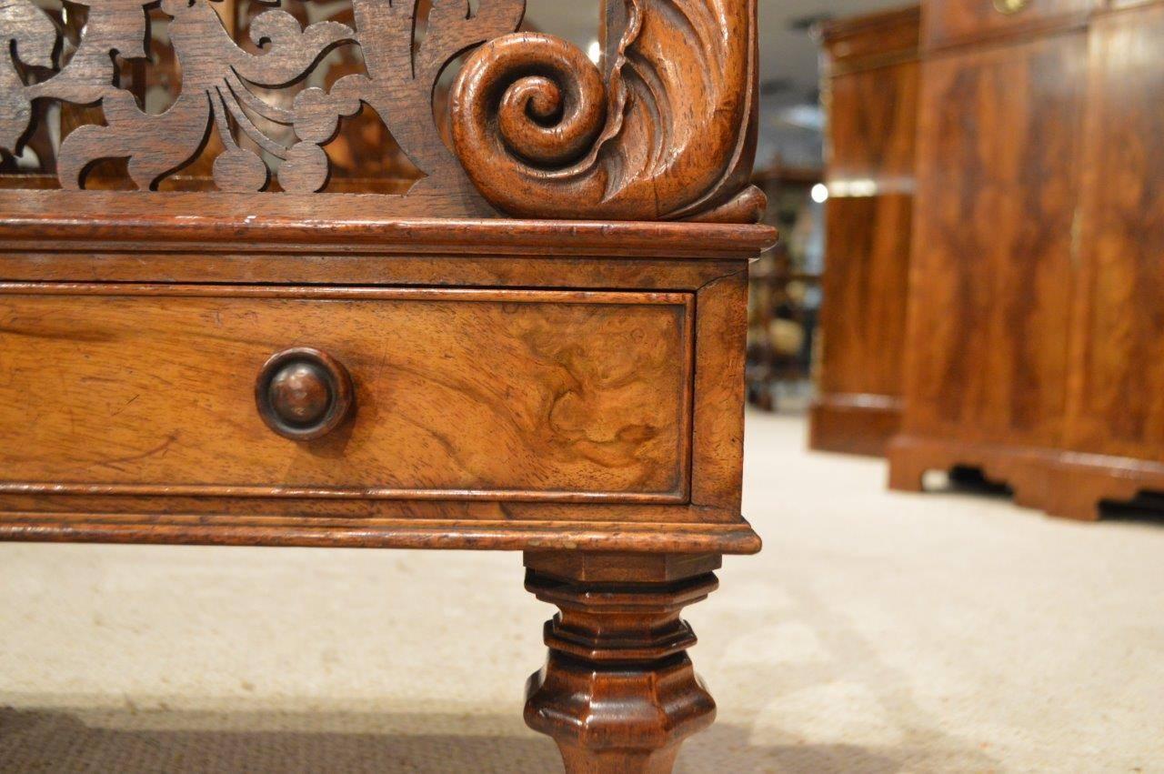A superb quality walnut early Victorian period antique Canterbury. With three magazine/newspaper divisions, the front and back divisions having wonderful pierced fretwork panels and finely carved acanthus detail. The rectangular mahogany lined