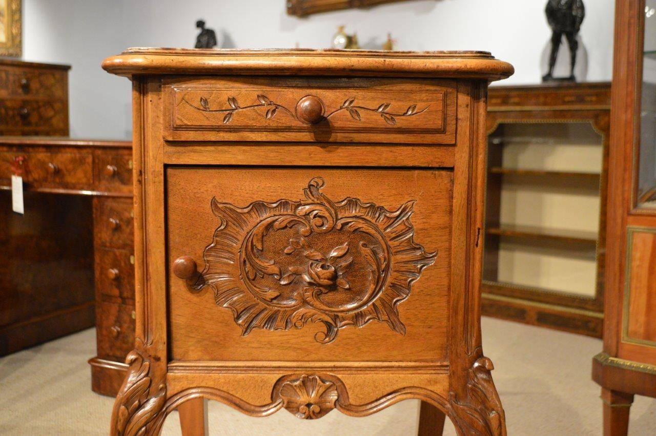 Walnut French Antique Bedside cabinet. With a grey and rouge marble top above a rectangular chestnut lined frieze drawer. The central carved rectangular cupboard door opens to reveal a porcelain lined interior, supported on carved french cabriole