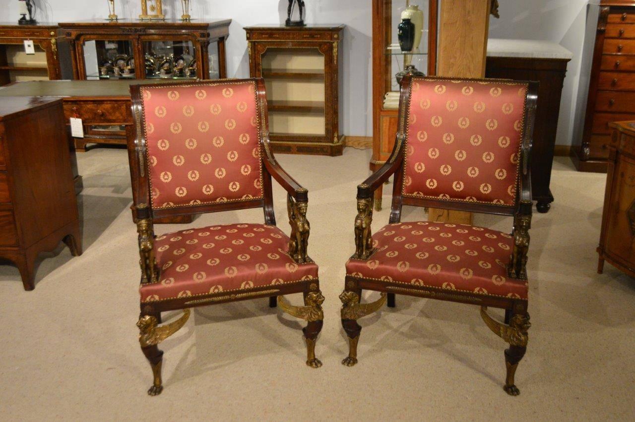  A fine pair of French Empire Revival mahogany & ormolu library chairs. Each constructed using the finest mahogany and with a padded upholstered back having finely cast ormolu mounts. The open arms supported by wonderful bronze Egyptian winged