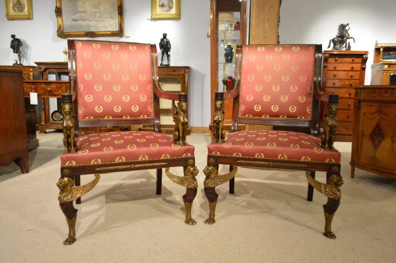 Late 19th Century A fine pair of French Empire Revival mahogany & ormolu library chairs. 