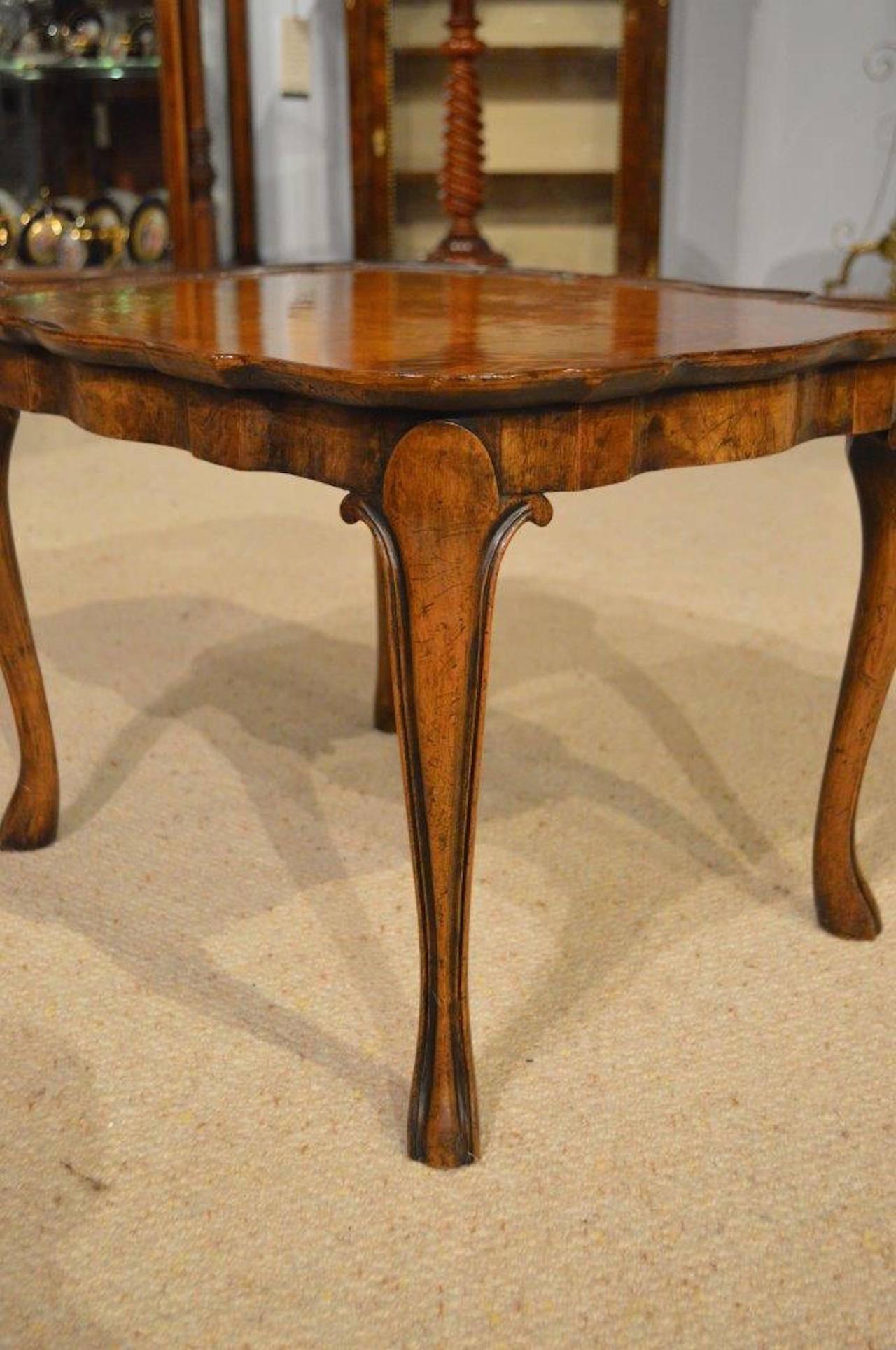 A small burr walnut 1920s Period antique coffee table. Having a shaped top veneered in beautifully figured burr walnut and a wavy walnut moulded edge. Supported on four elegant walnut cabriole supports English, circa 1920

Dimensions: 21
