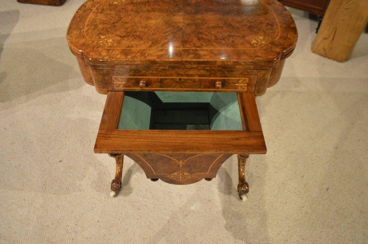 A fine quality burr walnut and marquetry inlaid Victorian period games/ chess/ work table. Having a shaped top veneered in beautifully figured burr walnut with tulipwood banding, with fine boxwood floral marquetry detail. The top swivels and opens