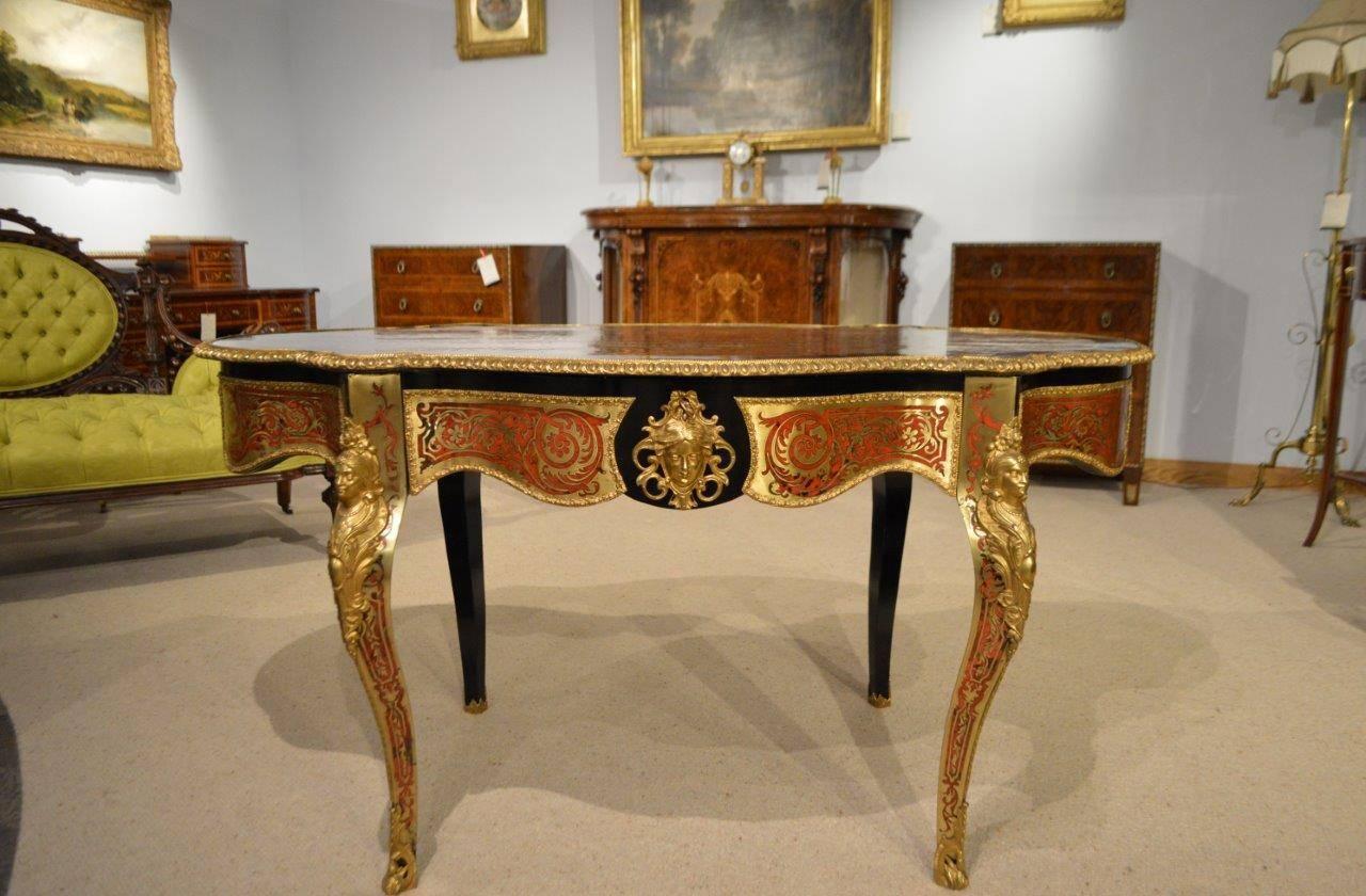 A stunning quality Louis XV style 19th century boulle centre table. Having a shaped top with a fantastic red tortoiseshell and boulle inlaid panel with an ebonized border and ormolu beaded edge. The table is decorated to the front, sides and reverse
