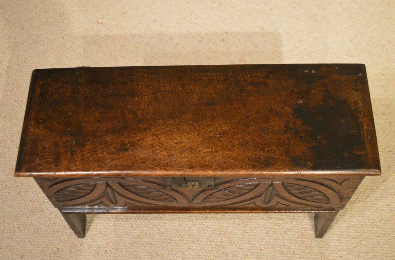 A small 17th century five plank oak coffer. The rectangular single plank hinged top, above a carved frieze with steel hasp and lock plate. Raised on stile end supports, England, circa 1680.

Condition: This coffer is in excellent condition, later
