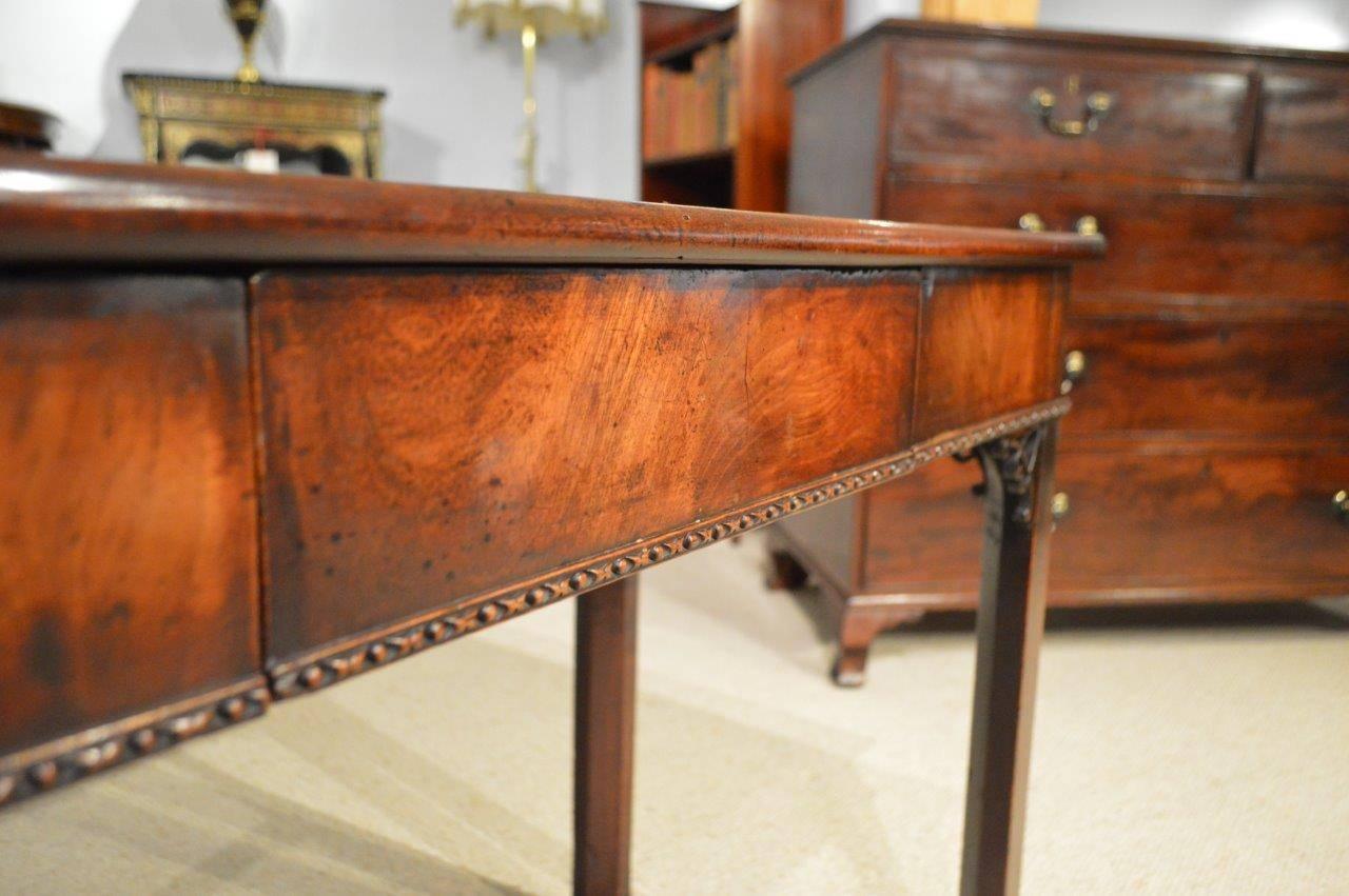 A fine Cuban mahogany George II period antique card table by Phillip Bell of London. Having a solid Cuban mahogany fold over top which opens to reveal the original baize lined interior above a flamed mahogany veneered frieze, with a concealed oak