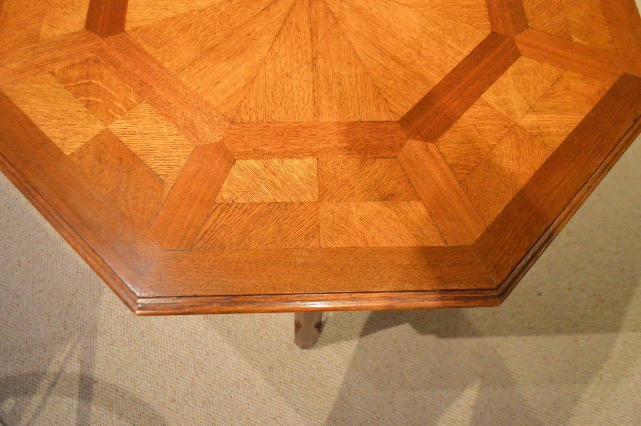 An oak Victorian period octagonal parquetry table by Howard & Sons of London. The octagonal top having fine parquetry segmented veneers and raised on Putinesque chamfered supports united by wavy stretchers. Stamped Howard & Sons to the
