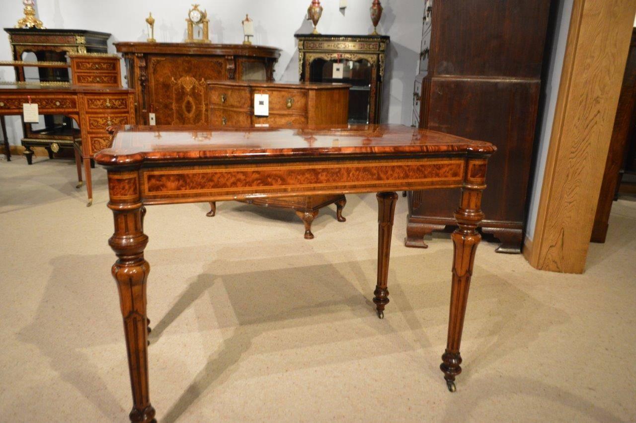 A fine quality thuya, burr walnut and kingwood Victorian Period fold over card table. Having a rectangular top with rounded corners, marquetry inlaid detail and having a central thuya panel with a geometric sycamore and boxwood line inlaid border,
