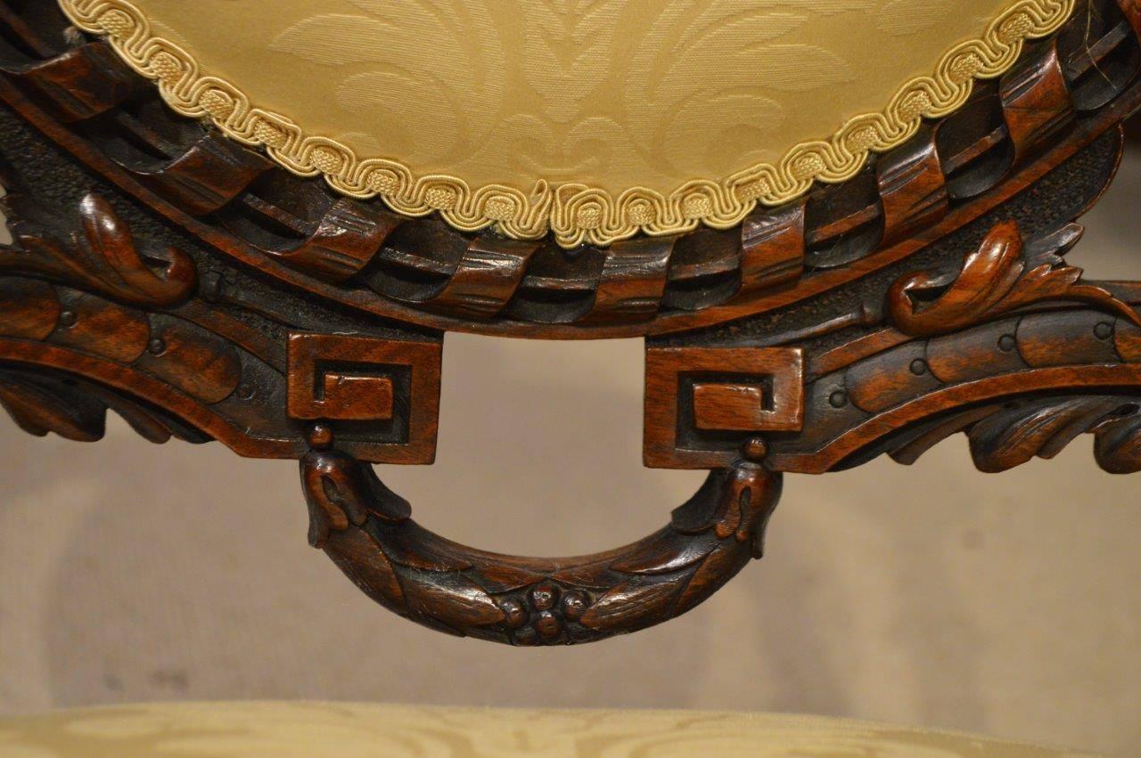 Stunning quality carved walnut Victorian period ladies and gents chairs. Each with a cameo padded back with finely carved rope twist moulding and fluted column supports and finials. The larger gentleman's chair with open arms and padded armrests