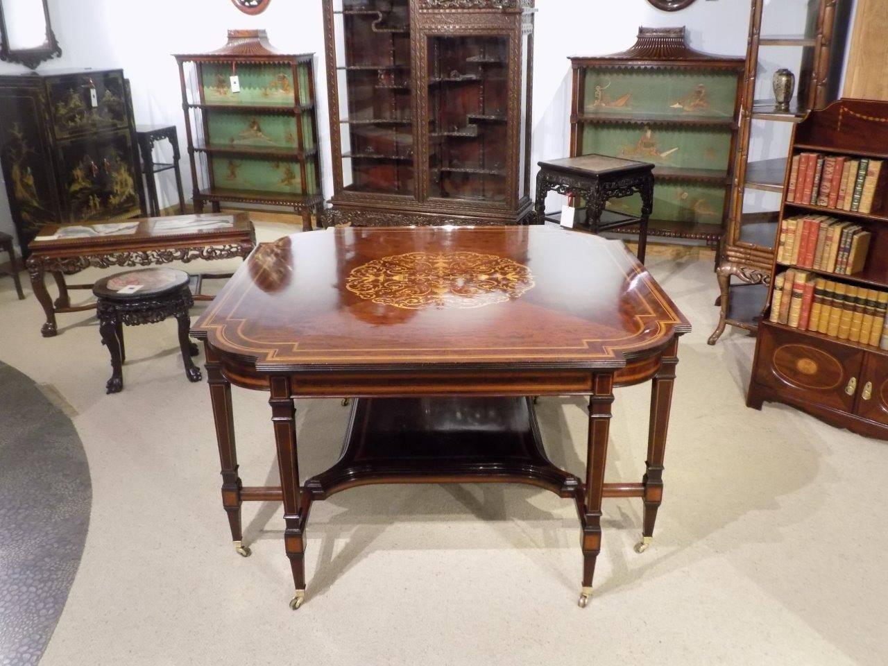 A large and rare mahogany inlaid Edwardian period antique centre table by Edwards & Roberts of London. Having a beautifully figured mahogany top with a double satinwood crossbanded border with a wonderful marquetry and pen-work central panel