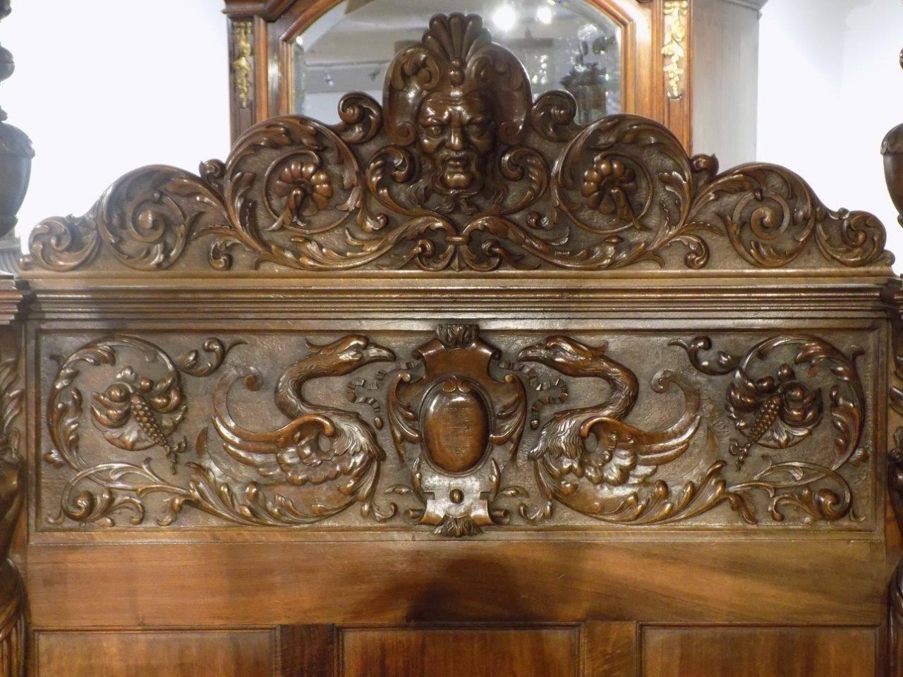 A finely carved Italian Baroque walnut four-poster bed single bed. Having an upholstered canopy raised on vase shaped turned columns with fine acanthus and anthemion carved detail. The head board again is exquisitely carved with a central satyr and