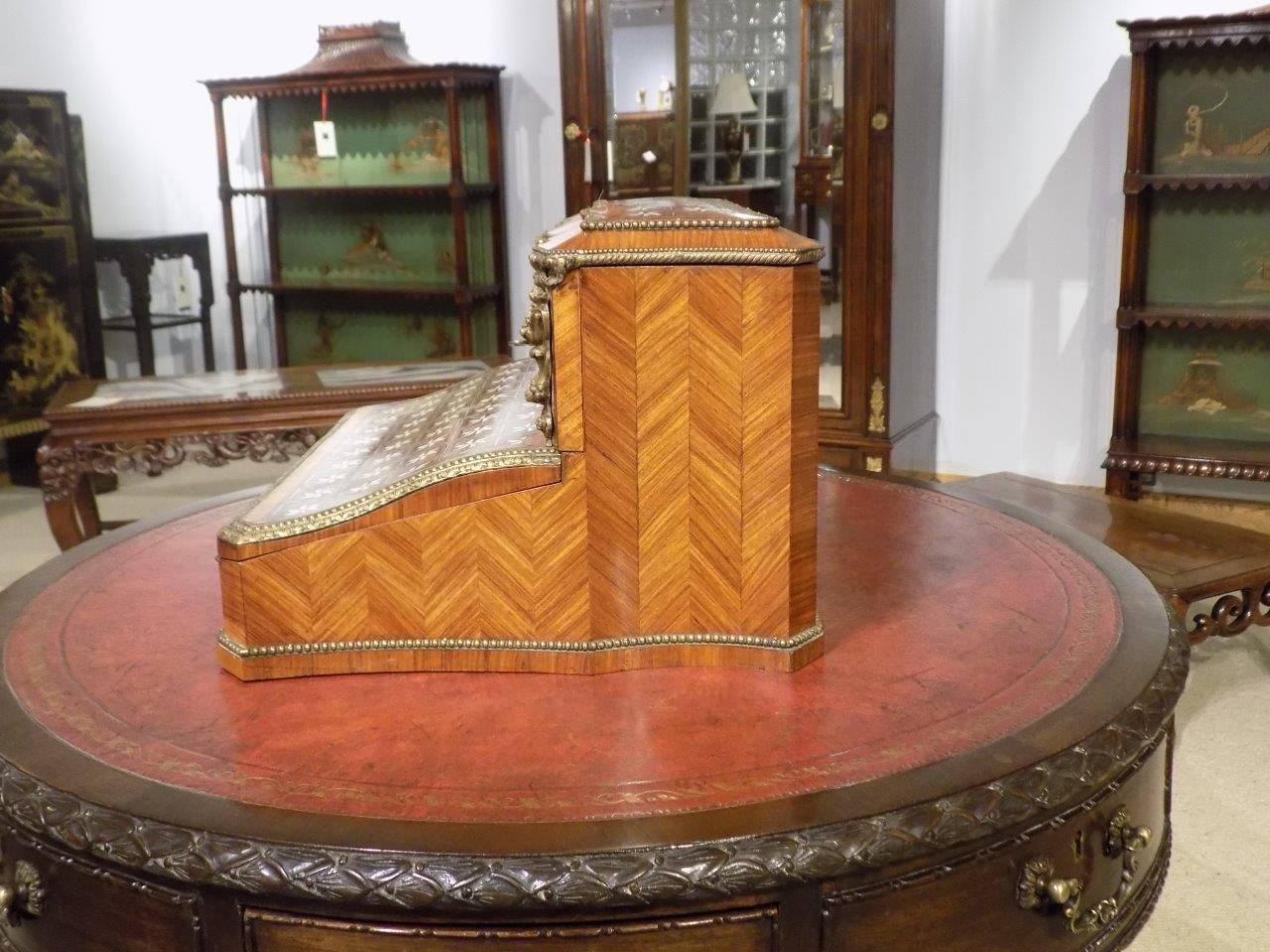 An exhibition quality kingwood and tulipwood parquetry inlaid French writing box constructed using the finest kingwood and tulipwood veneers with herring bone parquetry inlaid panels and finely cast ormolu and mouldings. The hinged top section