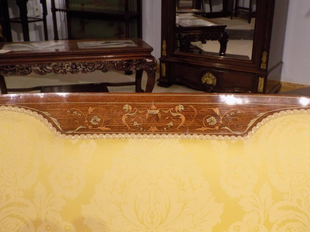 A fine quality mahogany, rosewood and marquetry inlaid Edwardian period sofa. The curved padded back with a fine classical marquetry and pen-work inlaid panel and string inlaid detail. Flanked by beautiful pierced and inlaid splats, with open arms