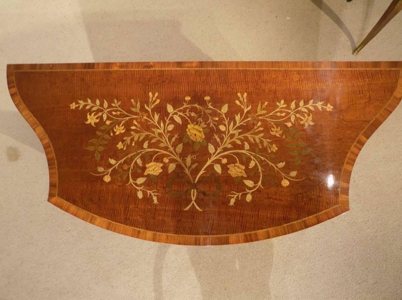 A stunning quality marquetry inlaid Edwards & Roberts serpentine side cabinet. The top of serpentine outline in fiddleback mahogany banded in kingwood and with Fine floral marquetry and pen-work inlaid detail. The front with central bow front doors