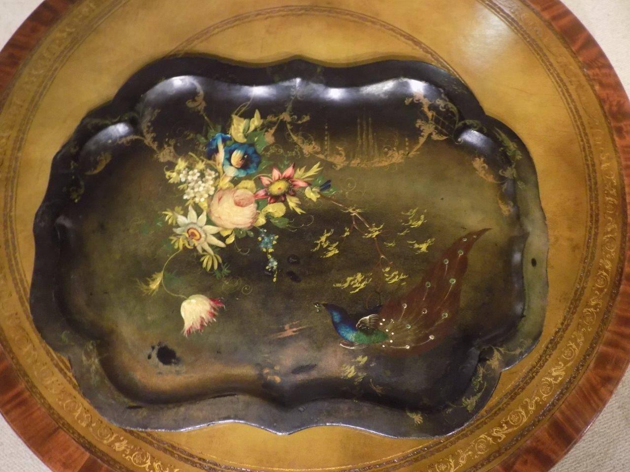 A Victorian period papier mâché tray. With a scalloped border and decorated with a peacock and floral detail to the black and gold lacquer ground. English, circa 1860-1880.

Dimensions: 30