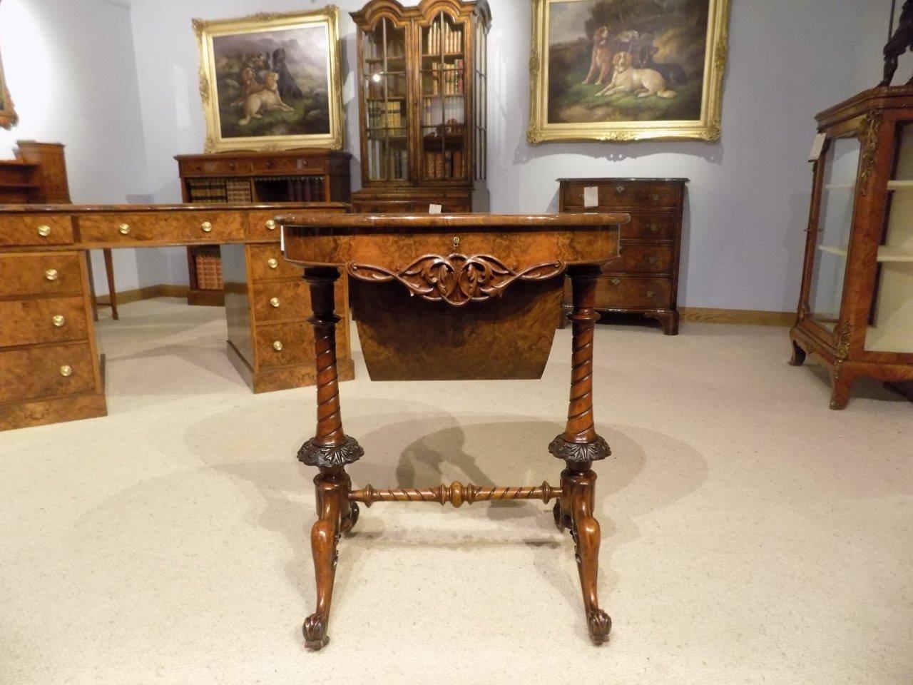 A superb quality burr walnut Victorian period oval shaped antique sewing table. The oval top is veneered in beautifully figured burr walnut and opening to reveal a pierced fretwork and boxwood interior and silk lined compartments. The hinged top