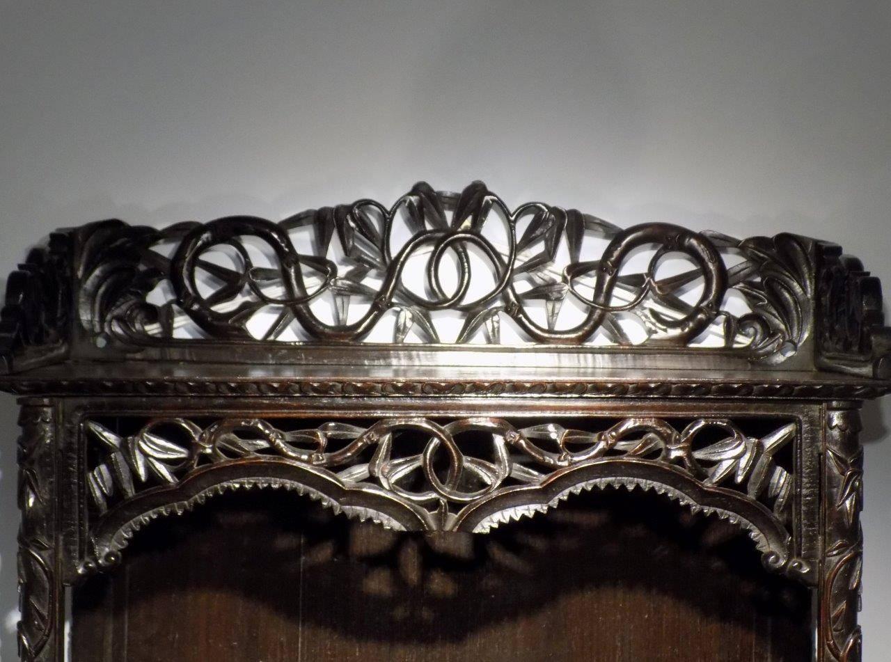 Carved 19th century Chinese open wall shelves. The finely carved gallery above two shaped shelves with faux bamboo supports and fine pierced fretwork detail. Chinese probably Huali wood, extremely heavy, circa 1880

Dimensions: 36