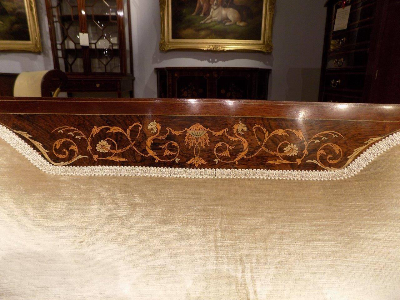 A fine quality mahogany and marquetry inlaid Edwardian period sofa. The curved padded back with a fine classical marquetry and pen-work inlaid panel and string inlaid detail, flanked by pierced and inlaid splats, with open arms and a padded seat