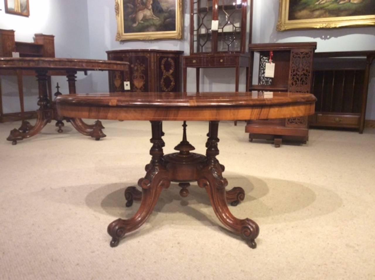 A beautiful small Victorian Period burr walnut oval coffee table. The oval top is veneered in beautifully figured burr walnut with fine floral boxwood inlaid detail and raised on four turned column supports with a central turned finial to the