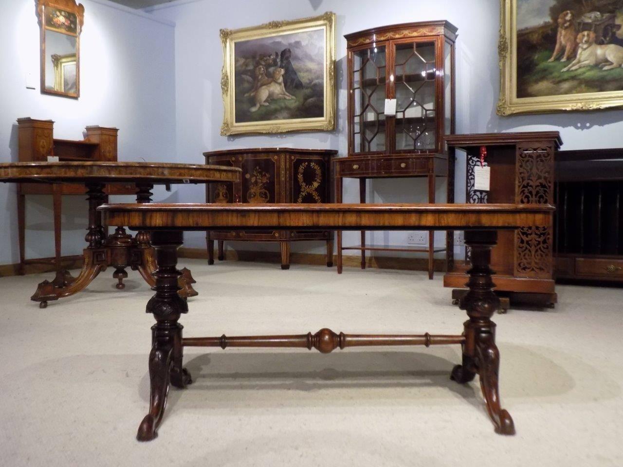 A superb quality burr walnut Victorian antique coffee table. Having a rectangular top with rounded corners veneered in beautifully figured burr walnut and supported on turned and finely carved columns, with acanthus carved swept supports and pad