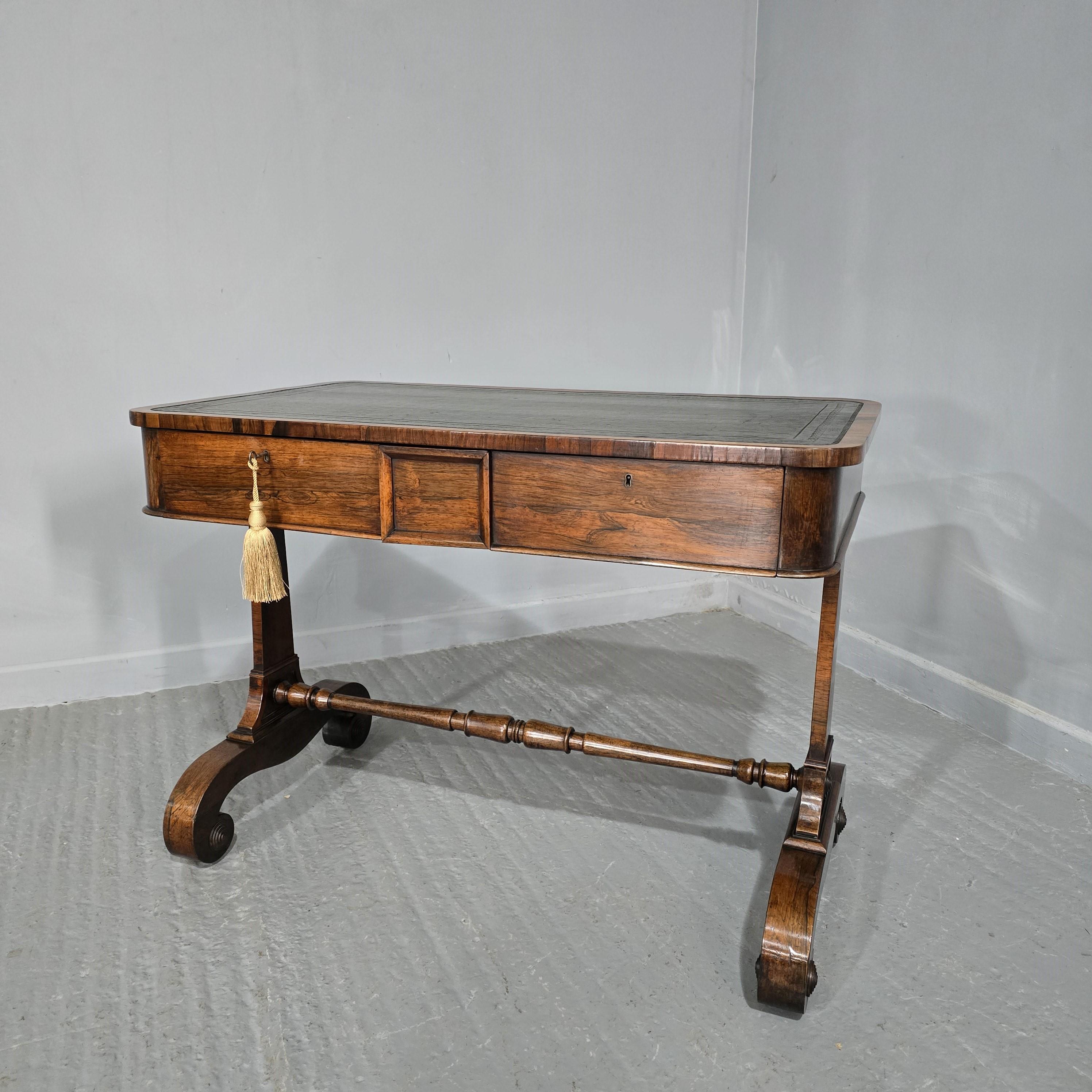 A excellent quality Regency rosewood writing or sofa table in lovely original condition, original green leather and wooden castors, two locking drawers.

29