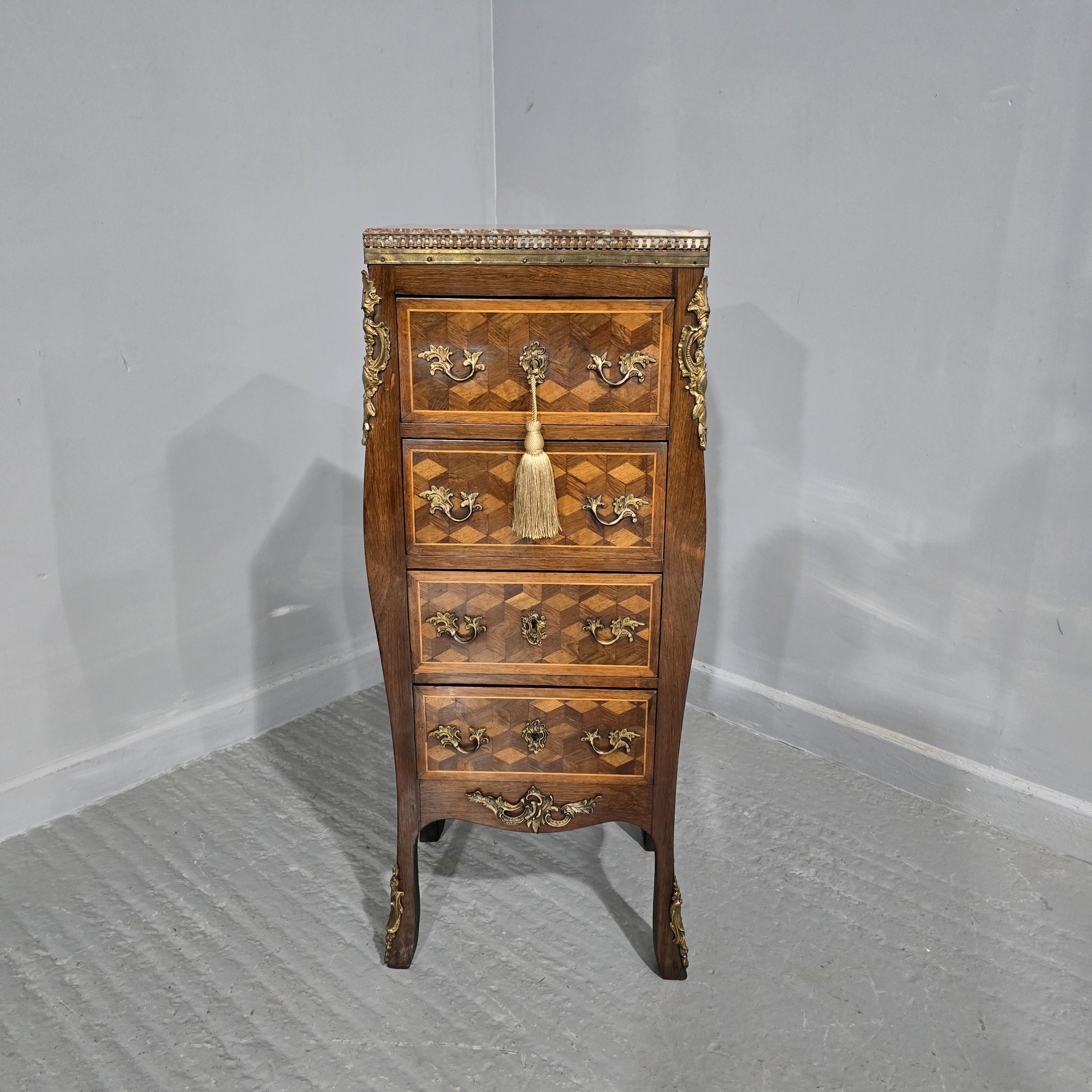 A very nice quality French parquetry four drawer chest of drawers of small proportions, with ormolu handles and mounts, brass gallery surroundng lovely marble, working key, in overall excellent condiiton.

38.5