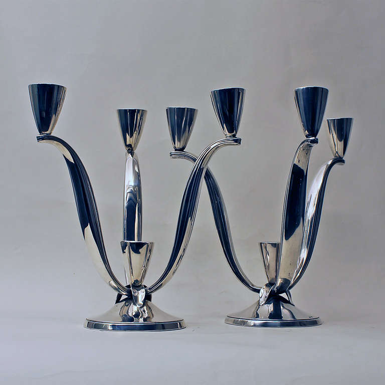 Pair of sterling silver candelabras, 3 arms, 4 candles, weighted bases.
Weight: 487 gr
Stamps: Star and (illegible) 9V
Star stamp is for sterling silver in Spain since 1934.
Barcelona, Spain, 1940s.

Star stamp is for sterling silver in Spain since