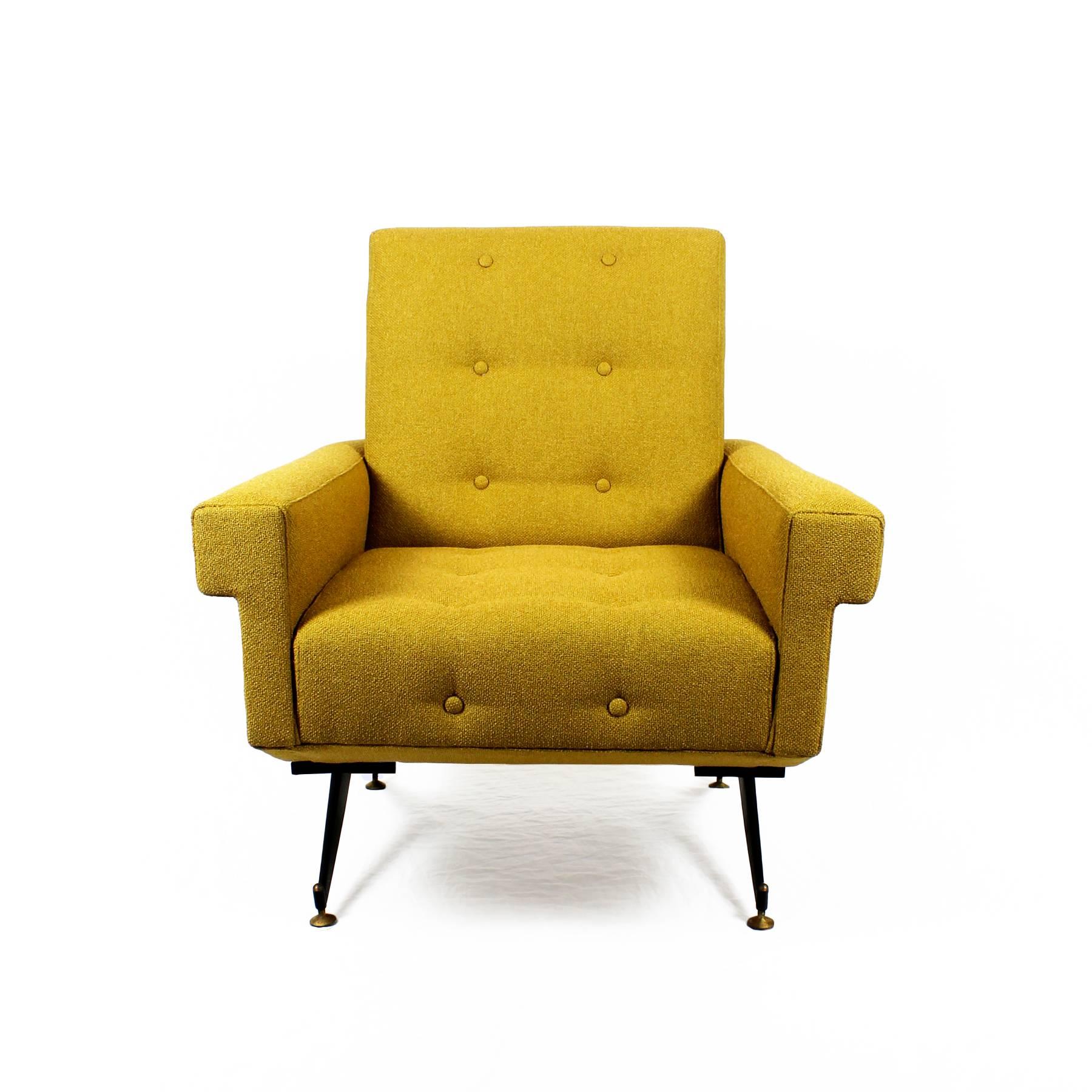 Spectacular pair of armchairs, black steel compas feet with polished brass nuts and bolts. Continuous arms around the back, new padded upholstery in yellow mustard bouclé fabric.

Italy, circa 1960.
 