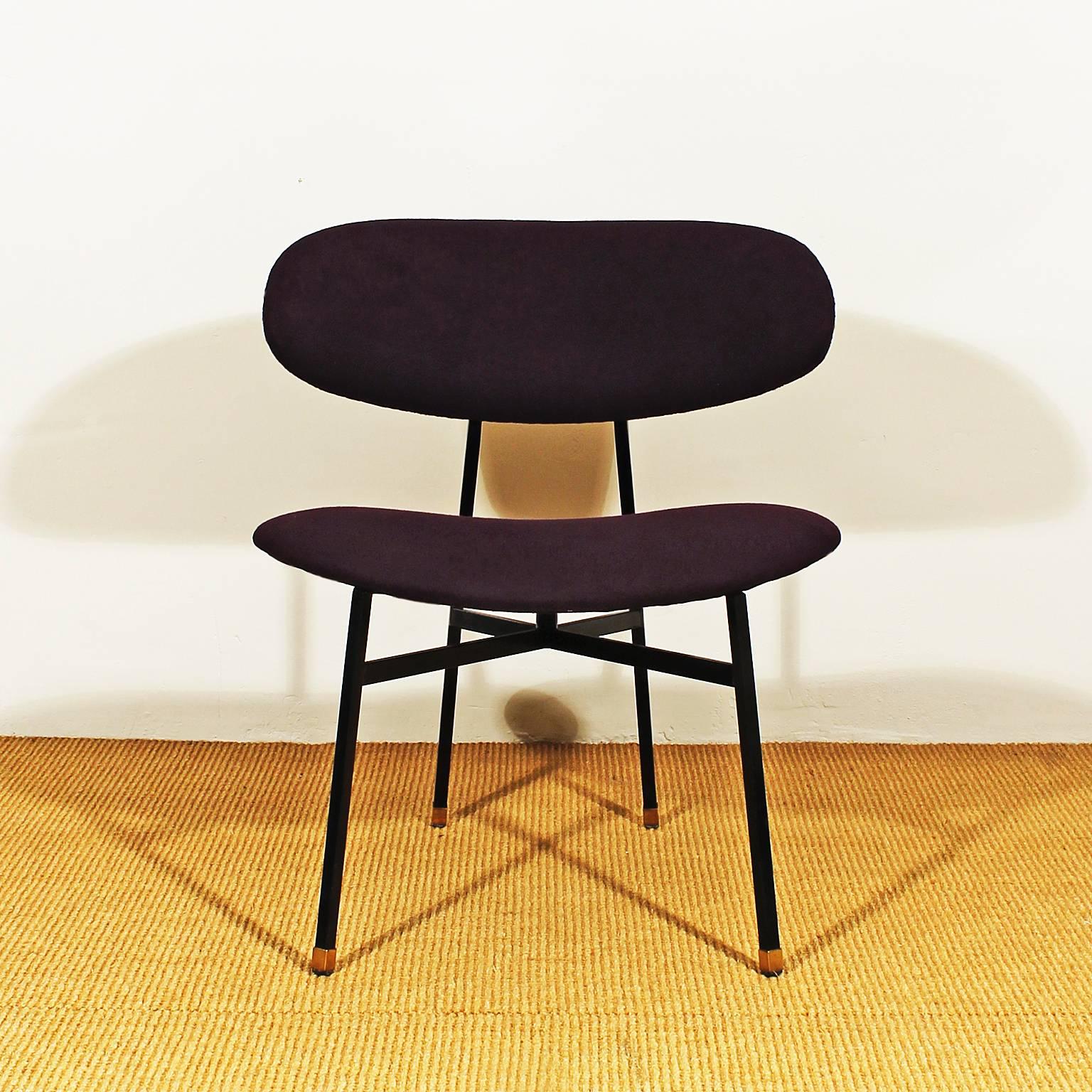 Pair of low chairs, black lacquered iron structure, polished brass hardware, curved seat and back, new violet felt upholstery,

Italy, circa 1950.