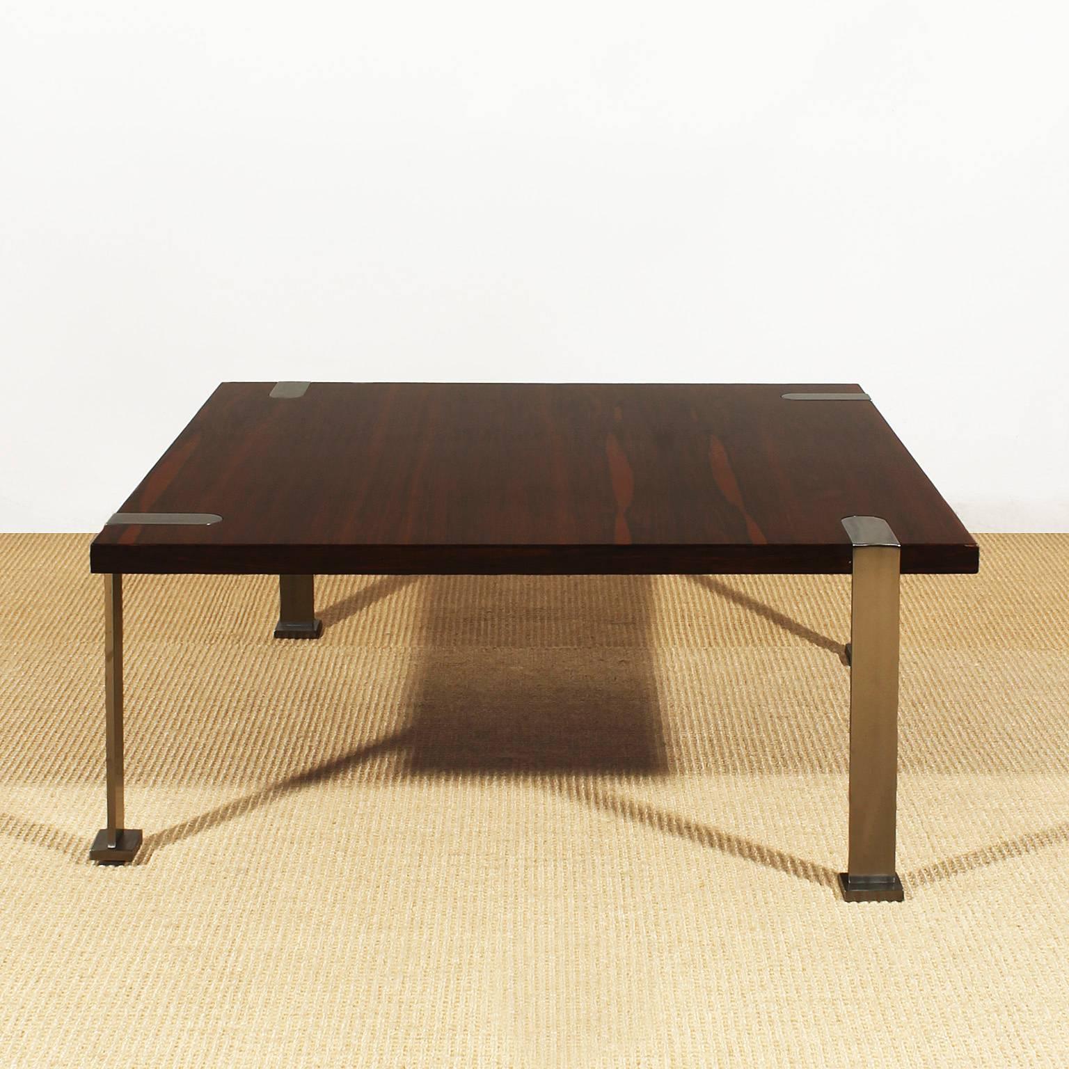 Coffee table, solid mahogany, mahogany veneer, french polish, asymmetrical polished steel stands.
Italy c. 1960