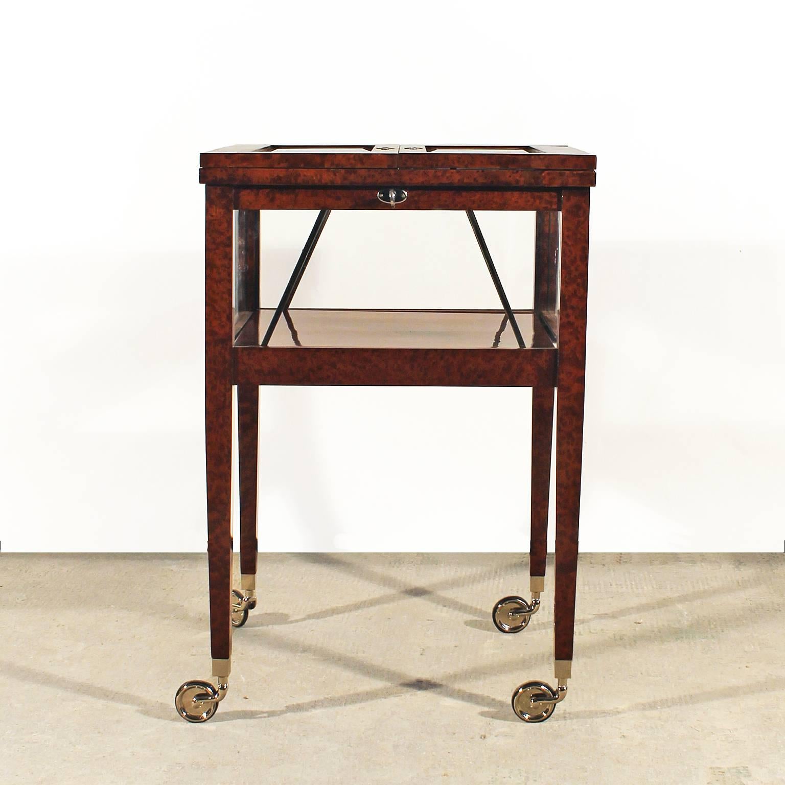 System Art Deco dry bar cart, burr walnut, French polish, with two doors on top with beveled glasses, nickel plated brass hardware.
By Bafico Paris-Buenos Aires,
France, circa 1930.

Measurement with open doors: 101 cm.