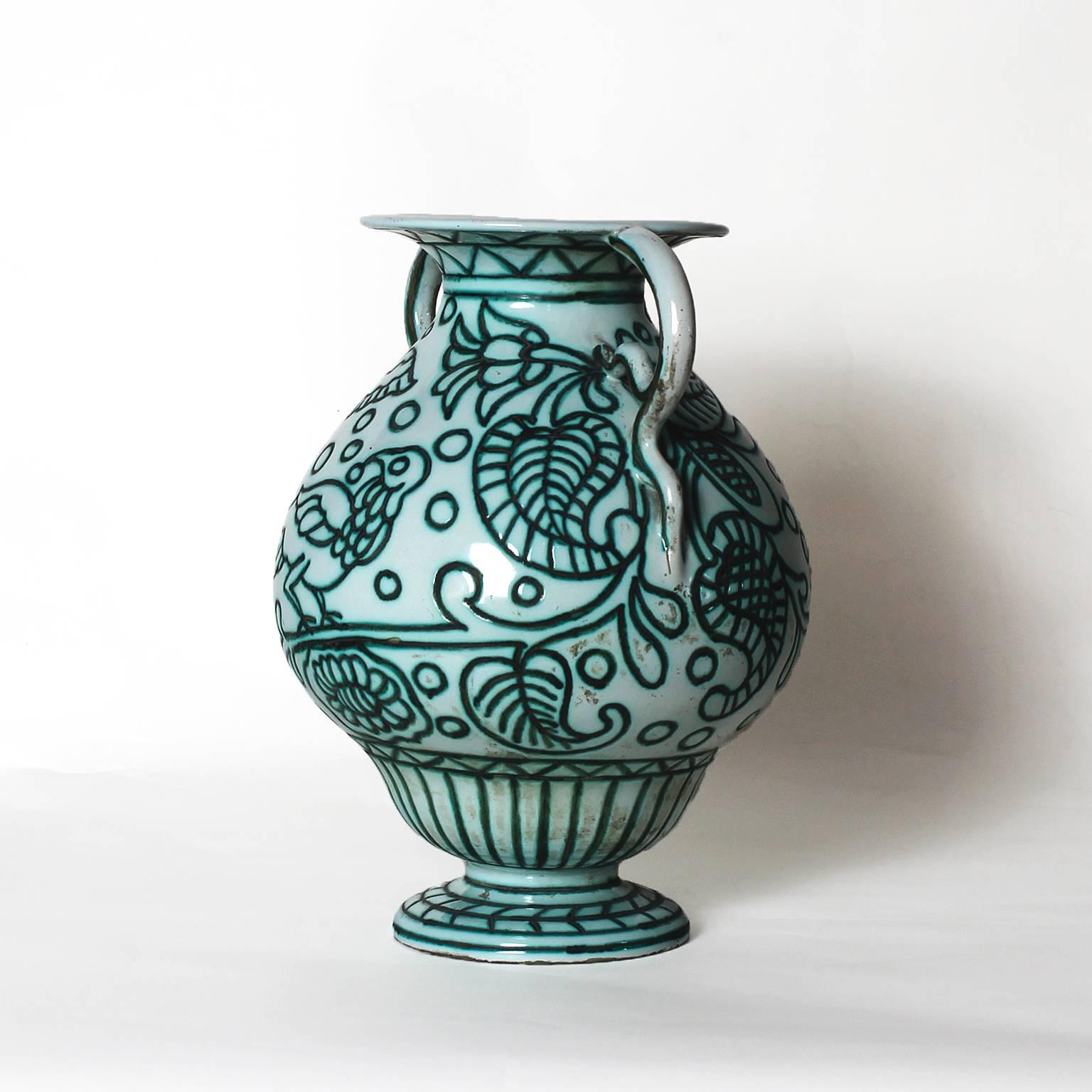 Ceramic vase with two handles, white and celadon green enamel, vegetal and bird decoration.

Maker: Casa Dell'arte. 

Italy, Albisola Capo, circa 1922-1925.