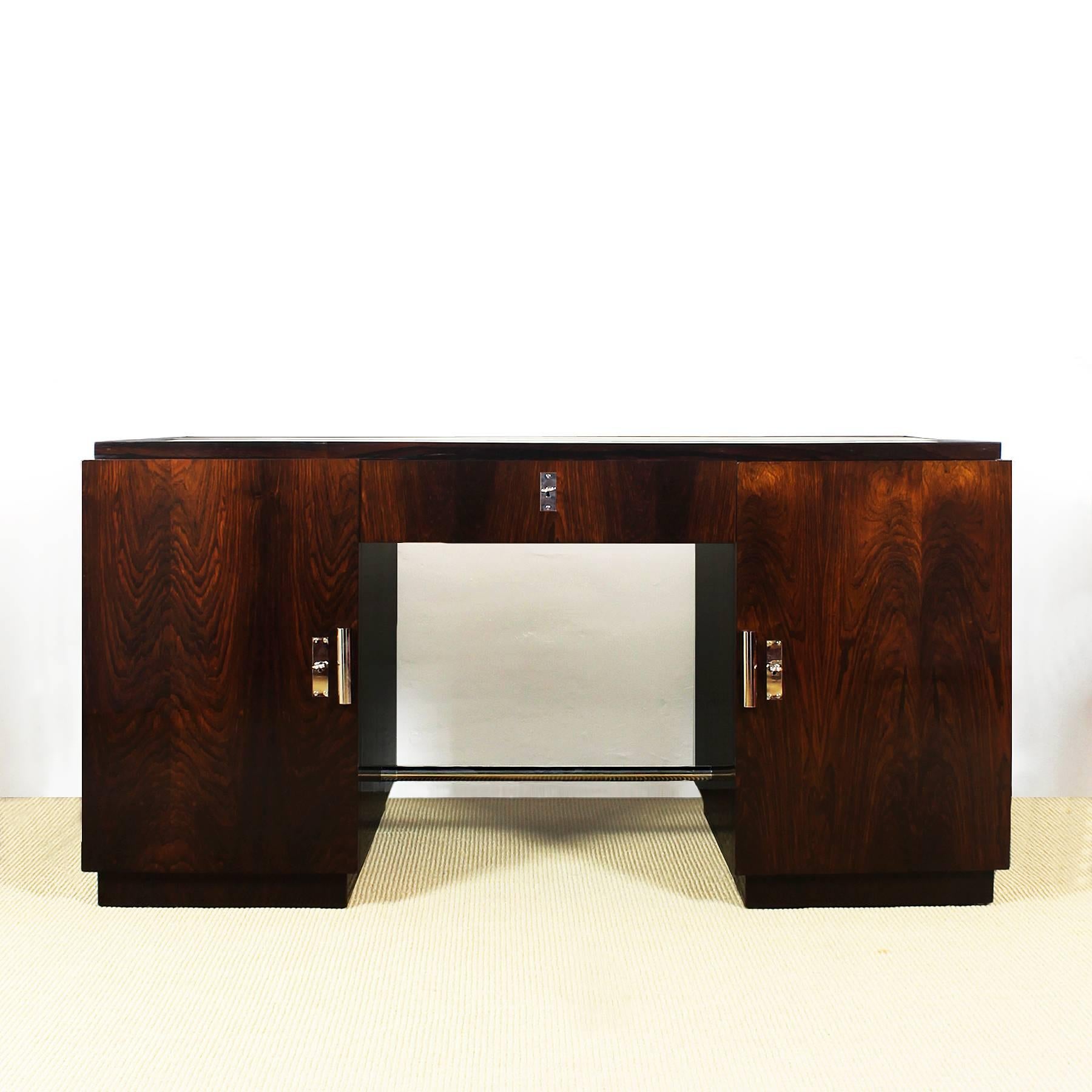 Spectacular set of Art Deco cubist desk and its armchair, Rio rosewood veneer, French polish. Double faced desk with three binders and a drawer in the left side and three drawers in the right one, large central drawer; full grain leather on top;