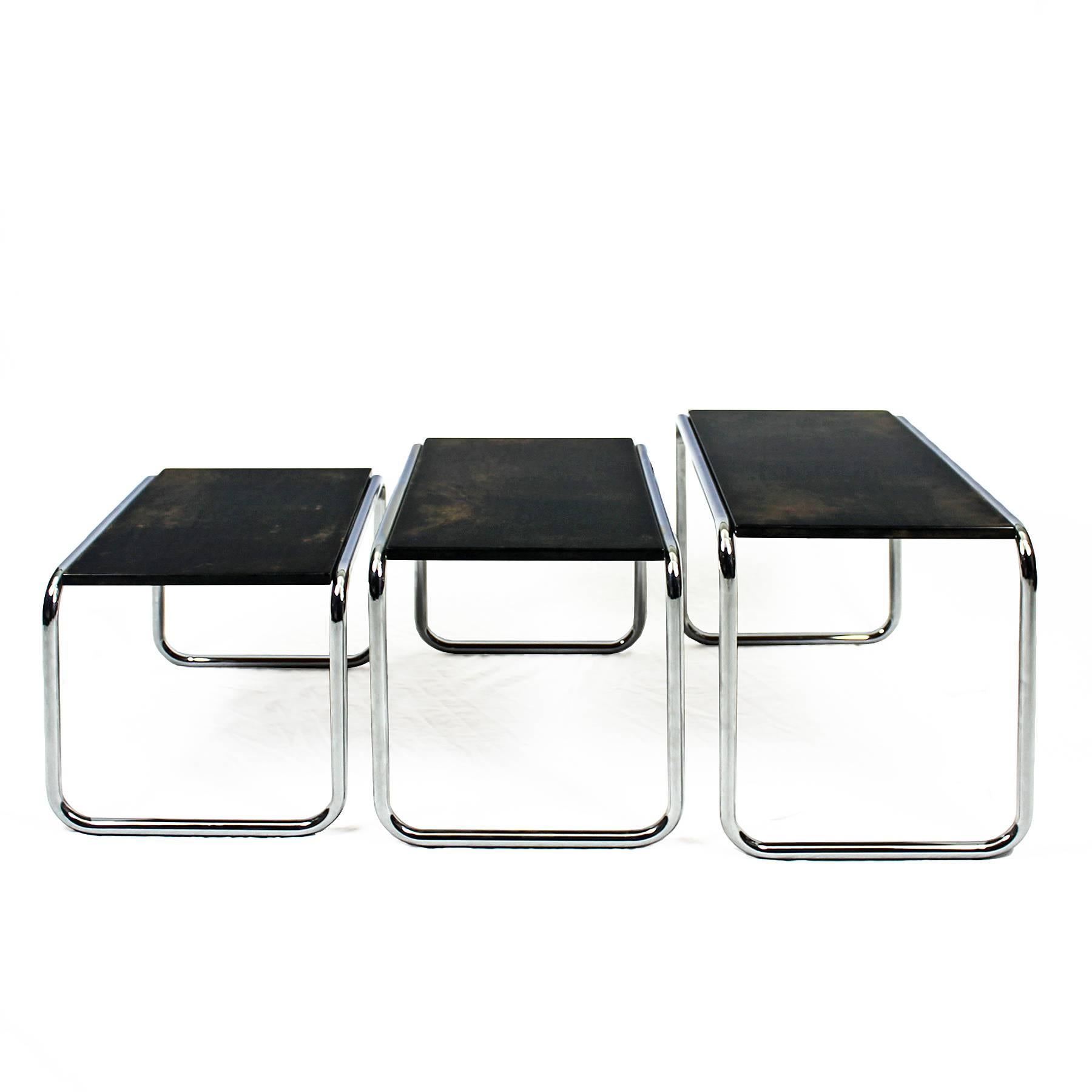 Splendid set of nesting tables, chromed plated metal structure, on top wood covered with stained and varnished parchment.
France, circa 1960

Measures: Big table 67 x 36 x 42 cm
Medium table 60 x 36 x 38 cm
Small table 52 x 36 x 34 cm.