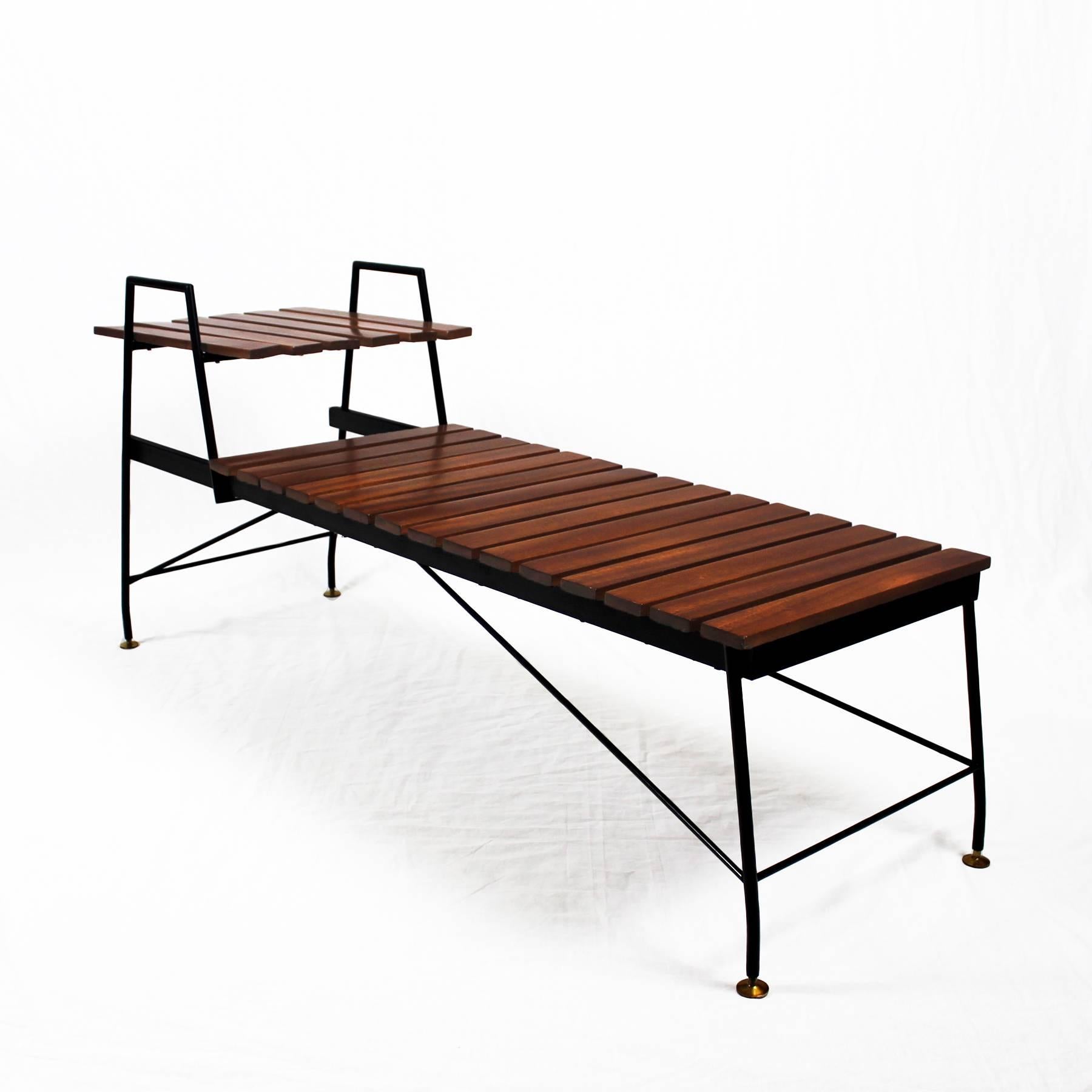 Bench-table, black lacquered steel structure and feet with brass finitions, satiny varnished solid teak slats.

Italy, circa 1950.

