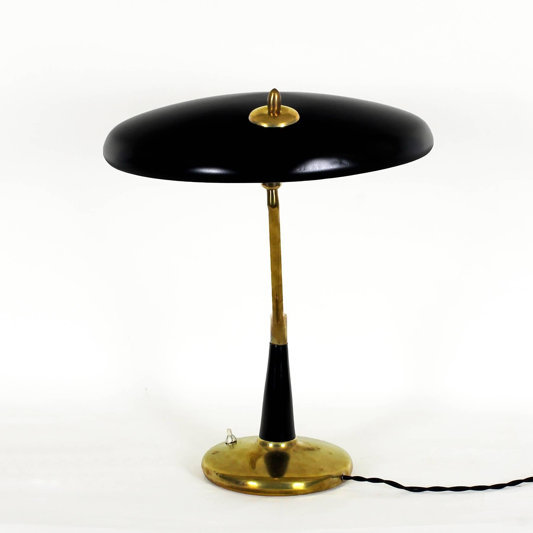 Spectacular table or desk lamp, polished solid brass and black lacquered sheet metal. Adjustable lampshade, new electricity system.
Design: Oscar Torlasco 
Maker: Lumi

Italy, 1956.