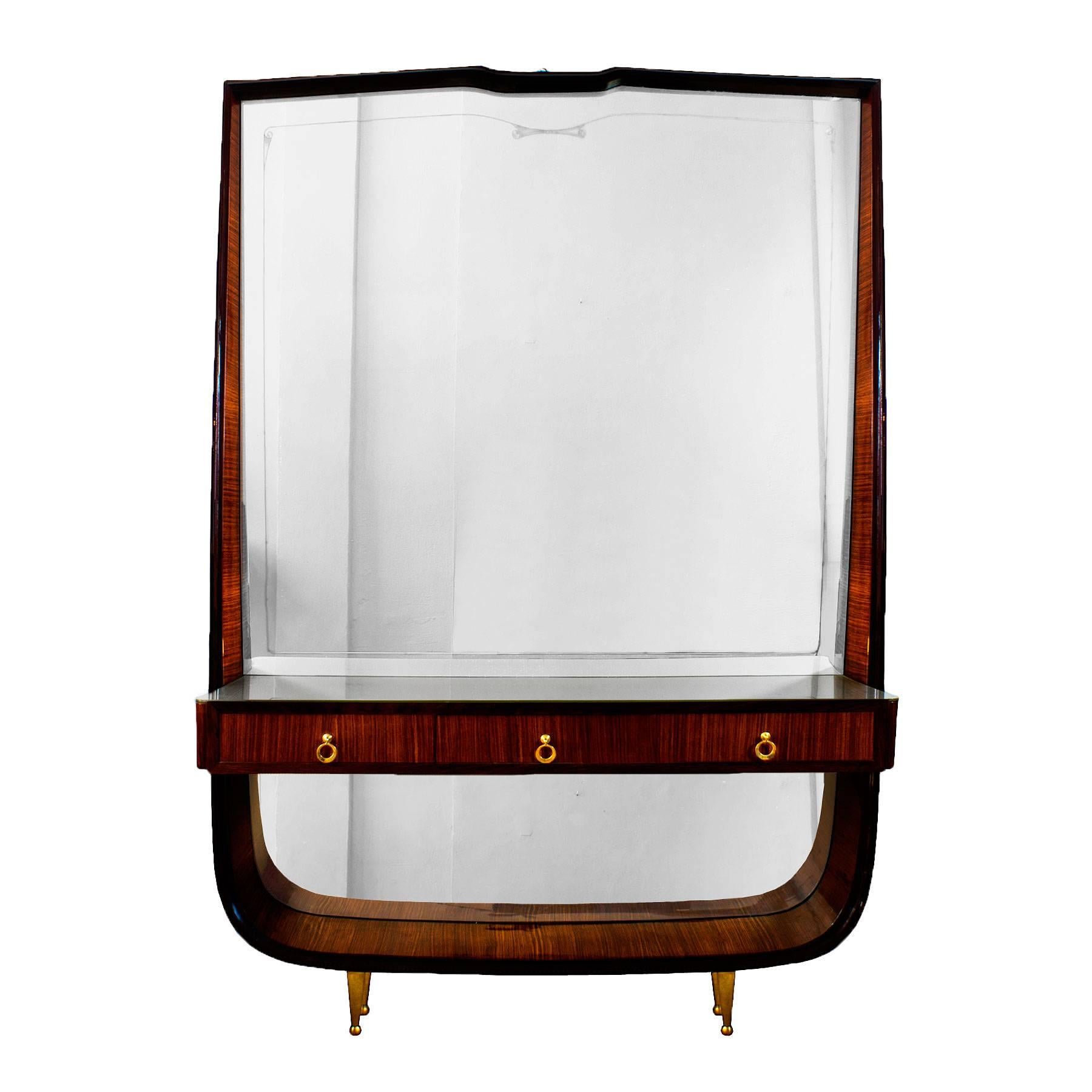 Entrance console - mirror, mahogany veneer with stained mahogany frame, french polish. Decorative engraved frieze in the original mirror (some oxidation), three drawers with a grey glass on top. Polished brass feet and handles.
Italy c. 1940